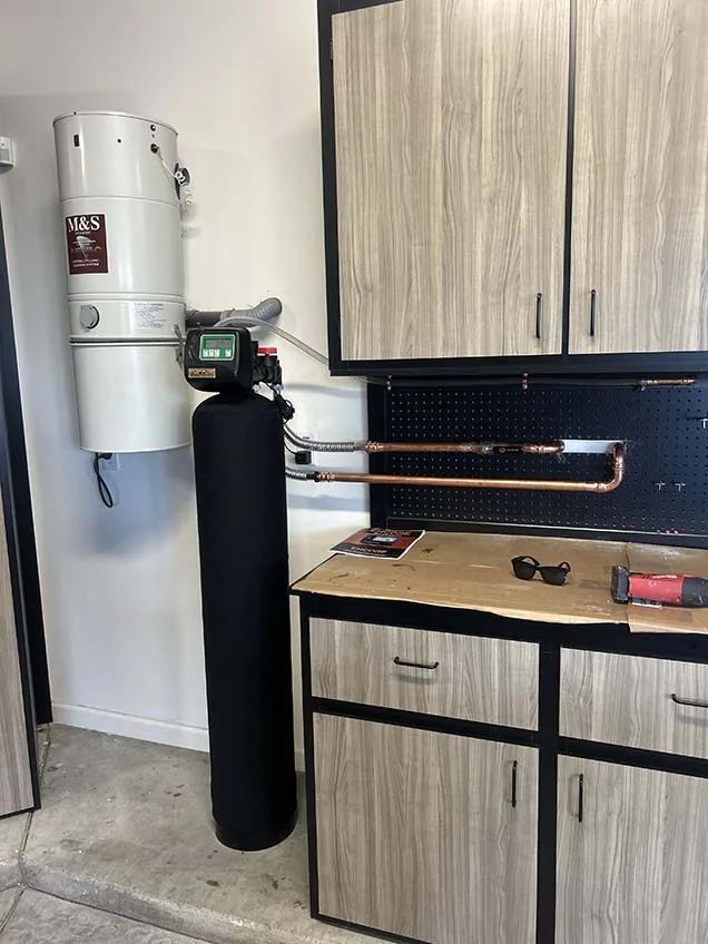 Garage water treatment system with copper manifold installed by Capstone Plumbing