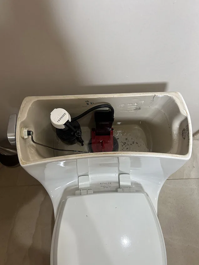 Kohler toilet tank with a new fill and flush valve installed by Capstone Plumbing